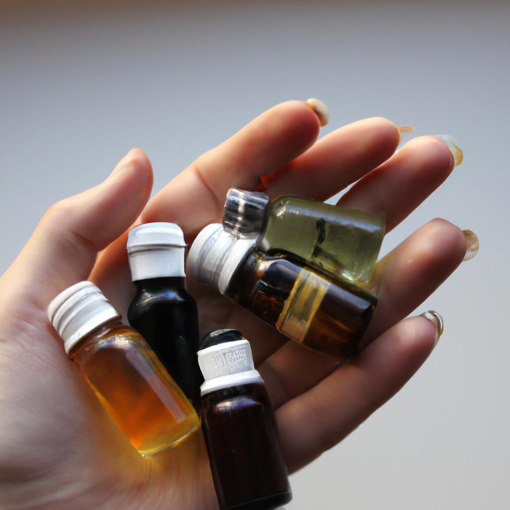 Person holding various essential oils
